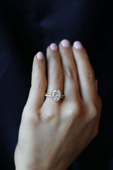 Oval Cut Bezel Set Engagement Ring with Millgrain Edge paired with radiant cut wedding band