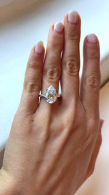 Pear cut engagement ring with baguette sides 